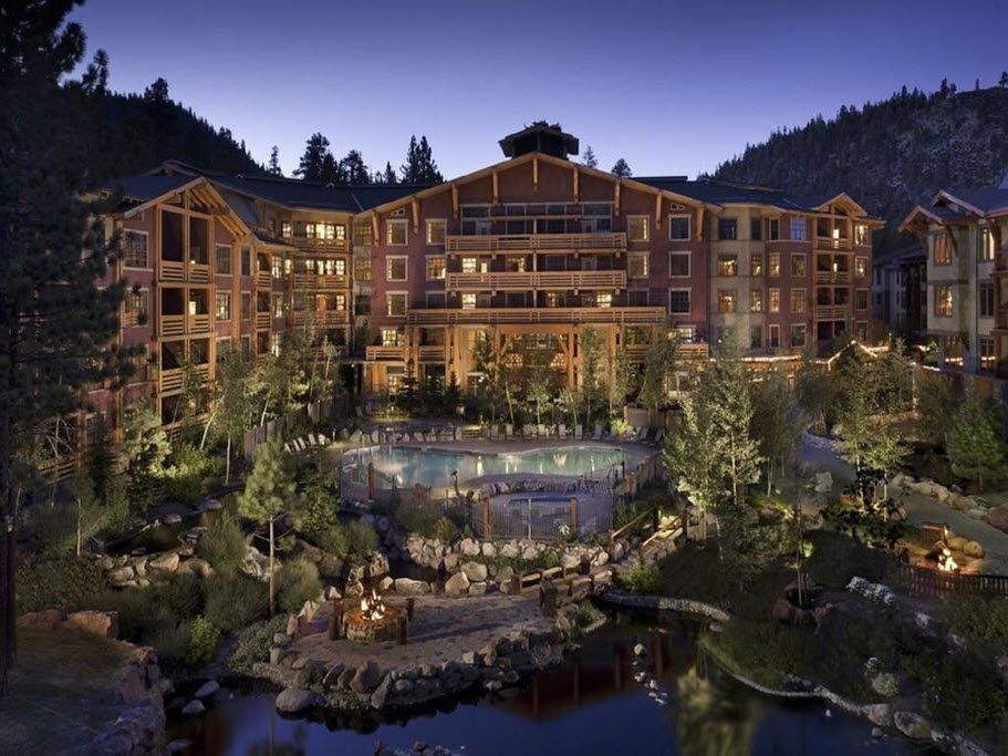 The village resort in Mammoth Lakes at dusk, with the pool, fire pits, and the two vacation condo units above