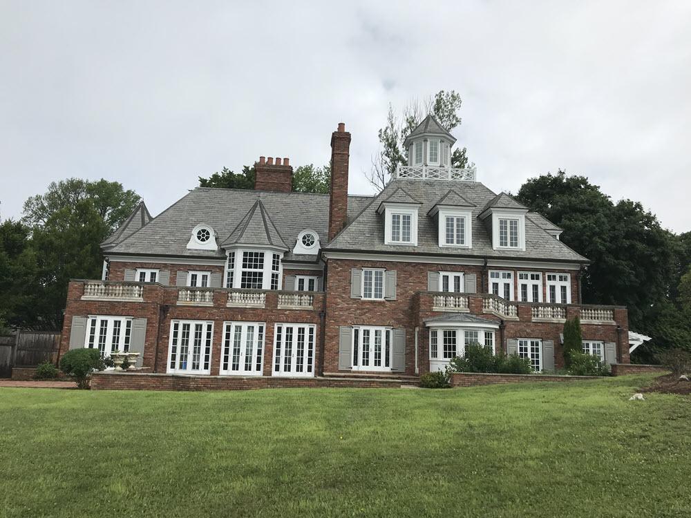 Renovated brick Georgian-style residence in Norwalk, Connecticut, viewed across its lawn