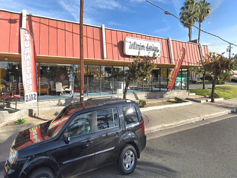 Owner-occupied furniture store building with a red standing-seam facade in Covina, California
