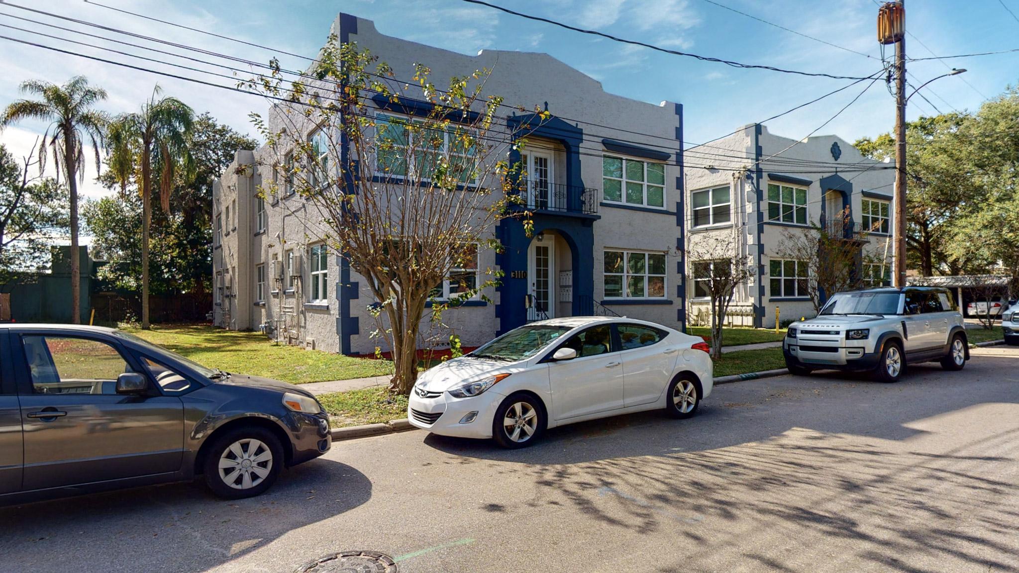 Two-story block-construction multifamily buildings with blue trim in Tampa, Florida