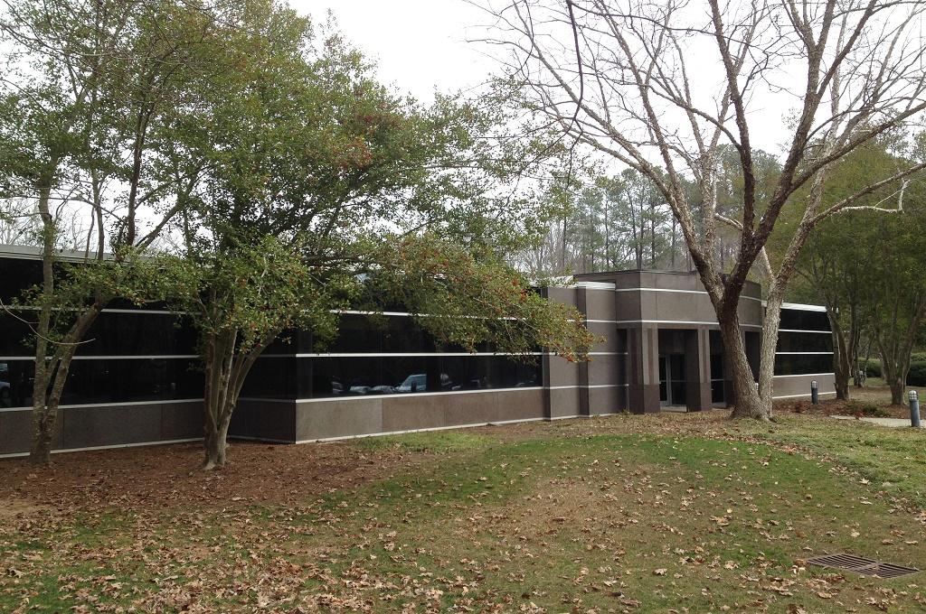 The bank-owned office building in Cary, a single-story property set back among mature trees